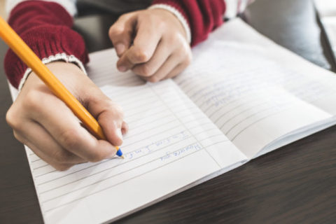 Child write in a notebook.